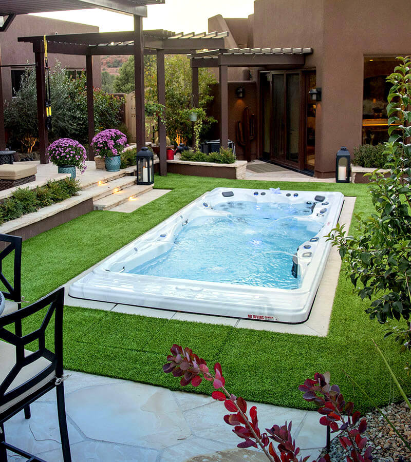 Master Spas swim spa installed in a landscaped backyard deck